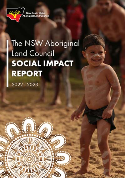 Cover of The NSW Aboriginal Land Council Social Impact Report 2022–2023; foreground child with body paint on sandy ground, group in background, decorative mandala graphic.